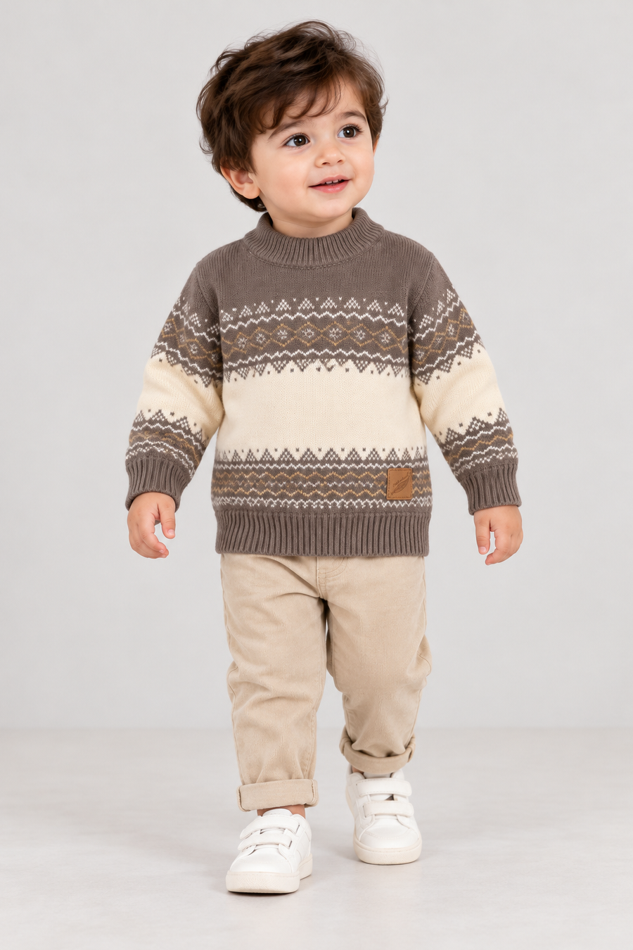 Toddler boy wearing Featherhead mocha brown Nordic winter knit sweater FB-4247 with beige trousers