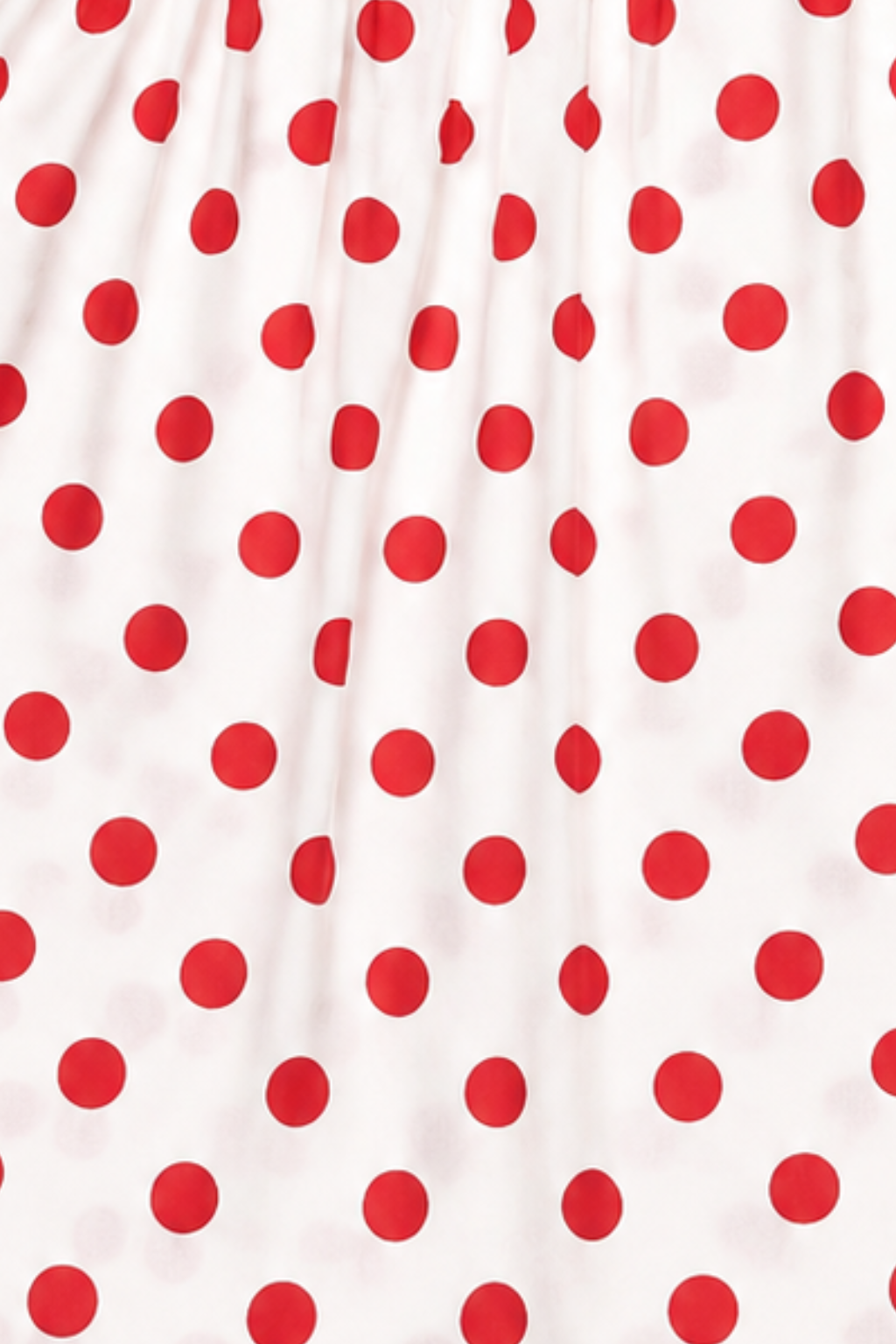 Close-up of red polka dot cotton fabric used in Featherhead Girls Dress FB-5593