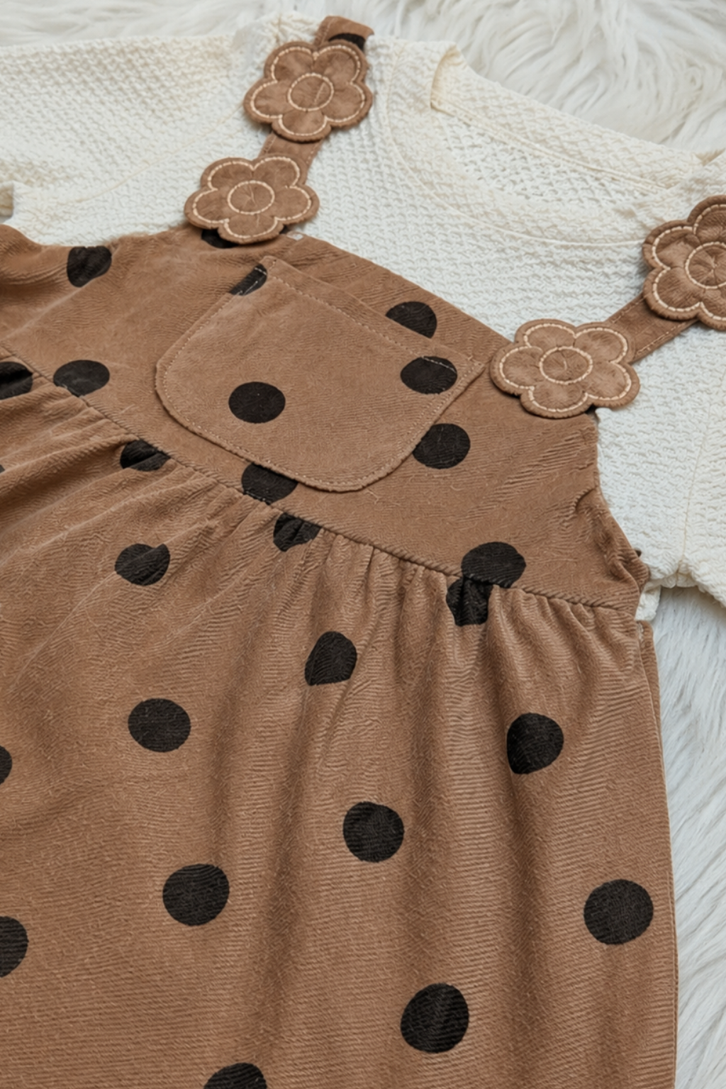 Close-up of beige polka dot cotton interlock fabric used in Featherhead Girls Corduroy Style Frock FG-5627