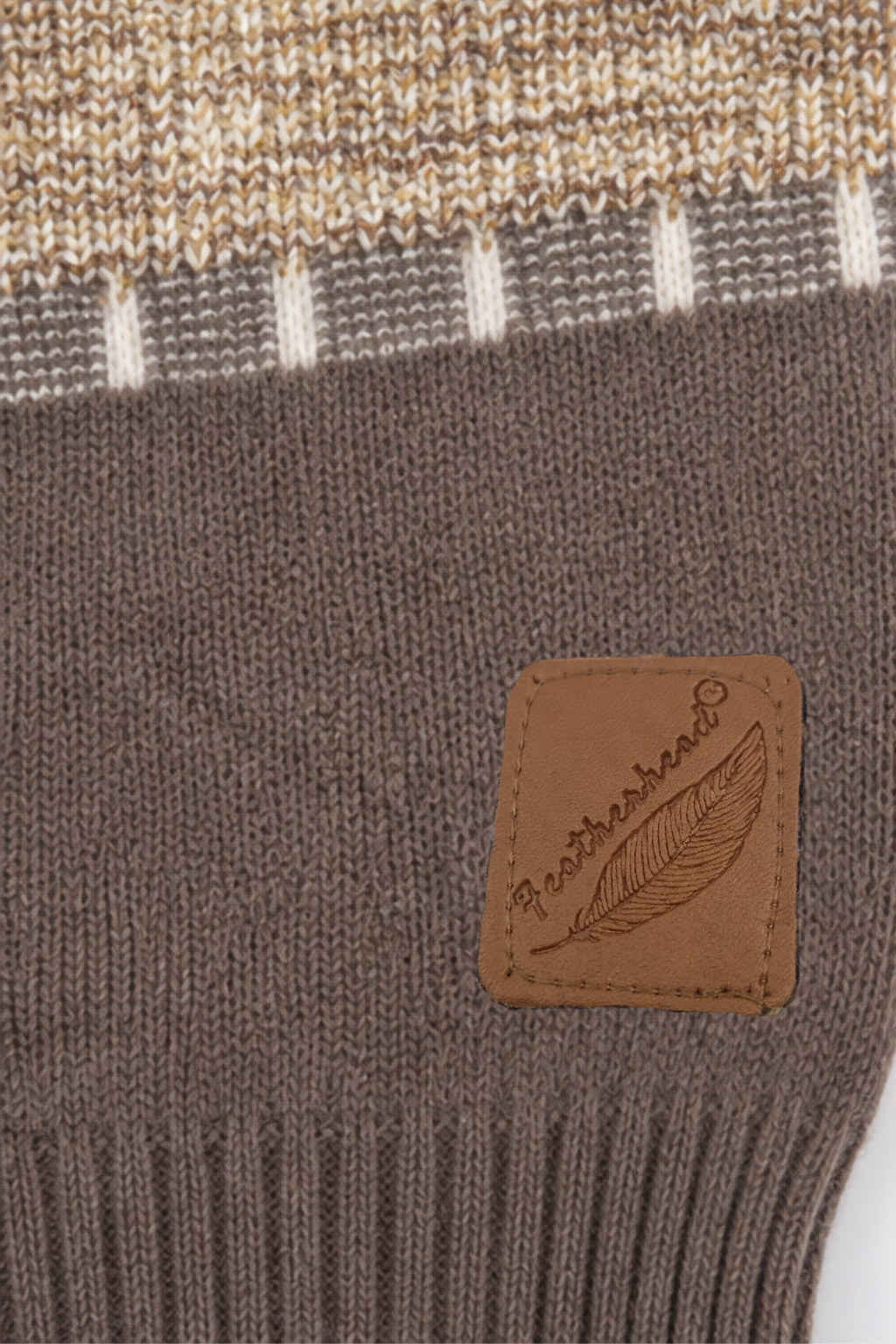 Featherhead signature brown logo patch on mocha brown ribbed hem of kids cable knit sweater FB-4291