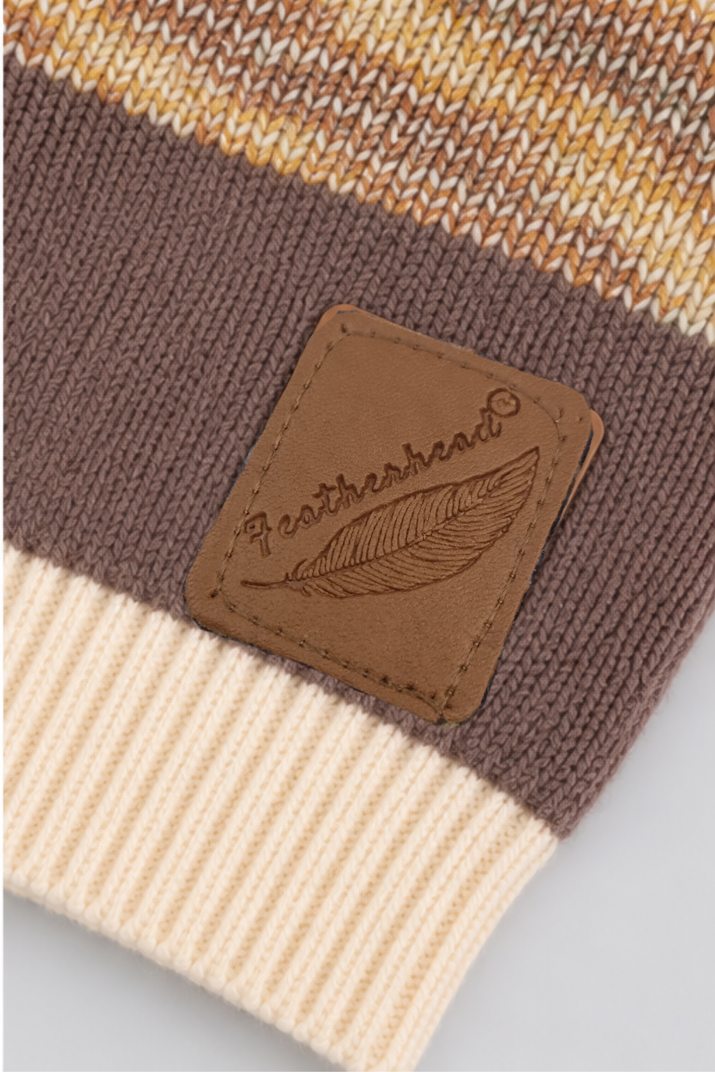 Featherhead signature logo patch and ribbed hem on chocolate brown cable knit boys sweater FB-4276