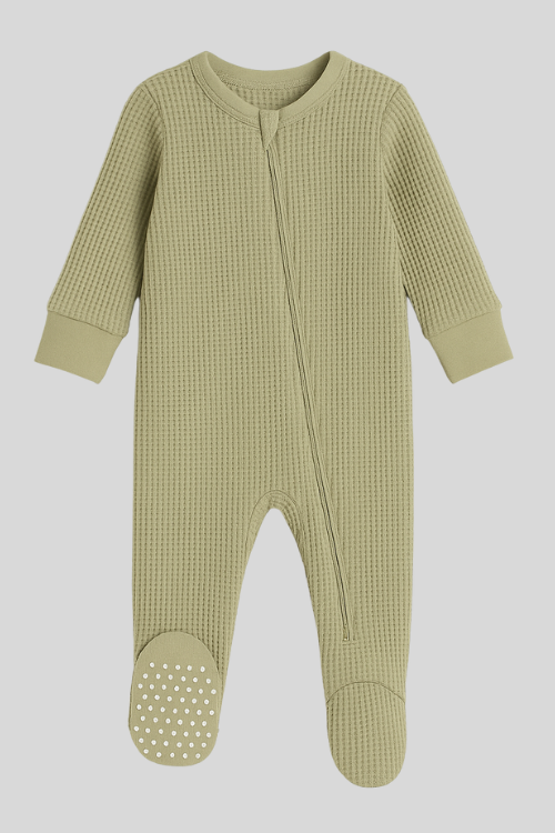 Flat lay of Sea Grass green cotton footed sleeper with zipper, Featherhead Baby