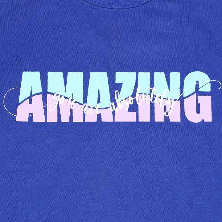 Close-up of “AMAZING” white graphic on purple shirt