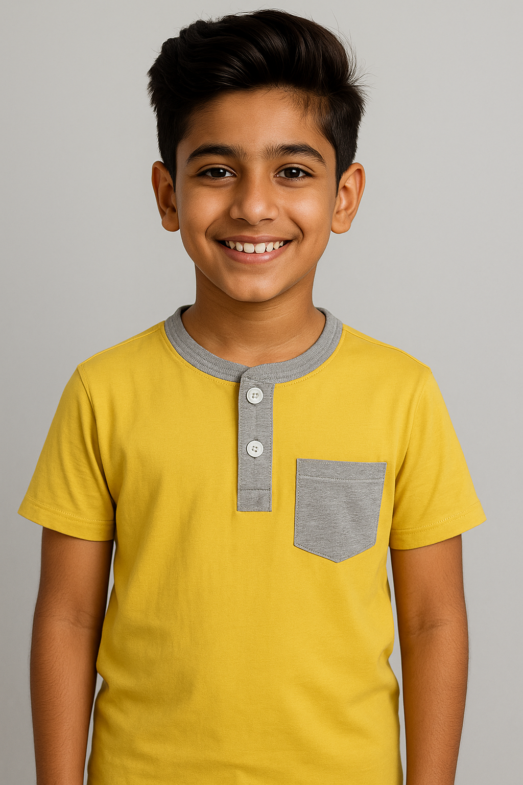 Boy wearing yellow Featherhead Henley shirt with grey pocket