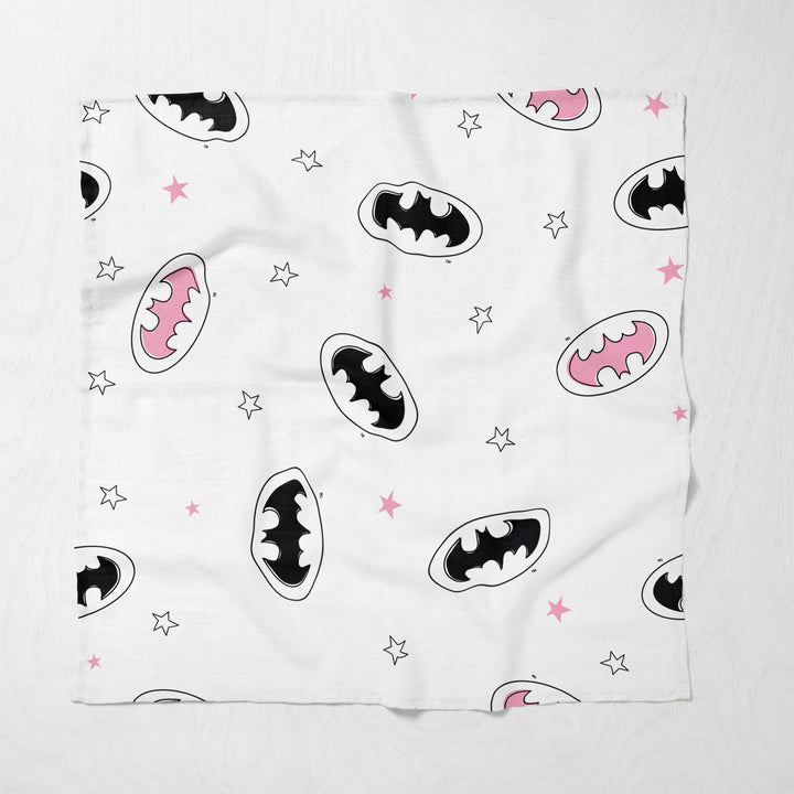 Close-up of white muslin blanket with pink and black Batman icons